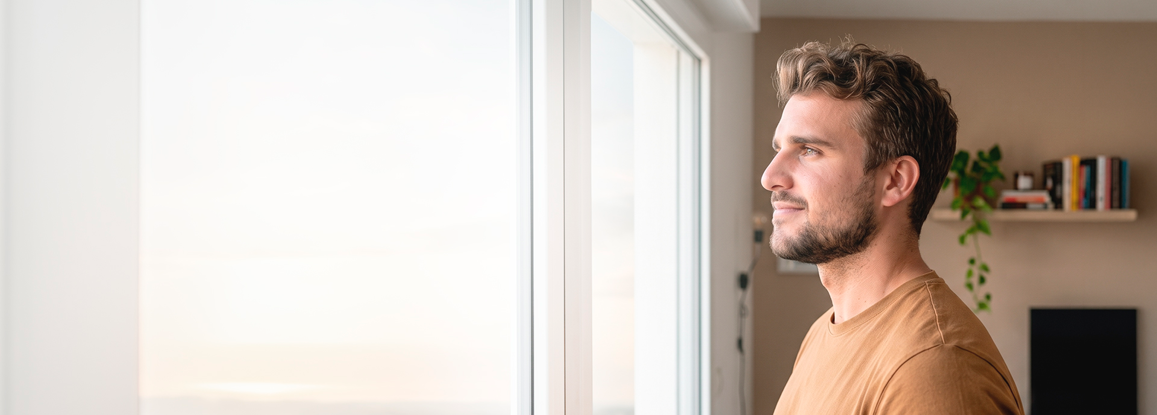 Man looking out a window in the Tirzepatide medical support hero